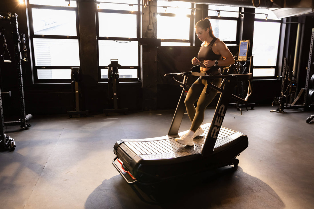 Athlete walks backwards on the Strive™ Curved Treadmill.