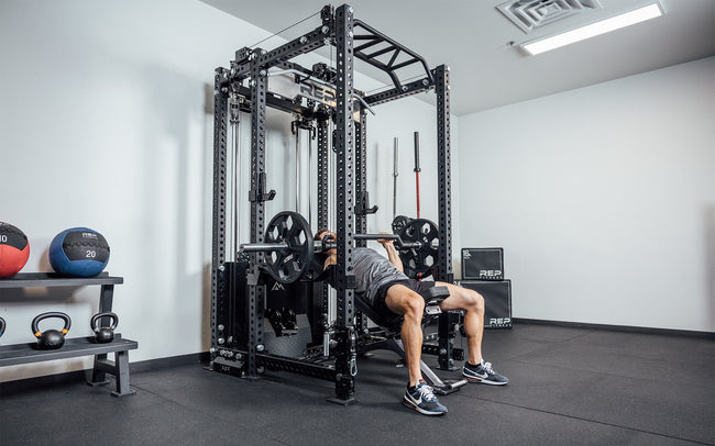 Man doing incline press inside a rack that has Ares 2.0