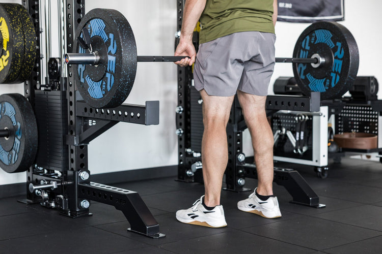 power rack with front foot extension pair 2.0 adding stability to front of rack while someone pulls from spotter arms