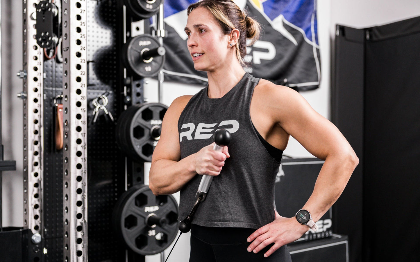 An athlete using the REP® x Kleva Built® ISO Pushdown Grip Cable Attachment to perform hammer curls